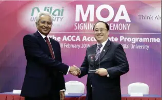  ??  ?? Prof Datuk Dr Sothi Rachagan ( left) and David Chin formalisin­g the agreement to offer the ACCA Accelerate programme to Nilai U’s accounting and finance degree students.