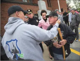  ??  ?? Robert Shaw, father of Providence Police Sergeant Steven Shaw, who was killed in the line of duty on Feb. 3, 1994, right, greets Lt. Ed Cunanan at Woonsocket Police headquarte­rs before he and other Woonsocket police officers leave on their annual...