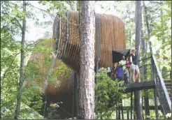  ?? The Sentinel-Record/Grace Brown ?? TREE HOUSE: The Colorado family, of Texas, exits the Bob and Sunny Evans Tree House in the Evans Children’s Adventure Garden on Tuesday. Garvan Woodland Gardens hosted a soft opening on June 30 to celebrate the Tree House’s completion.