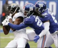  ?? SETH WENIG — ASSOCIATED PRESS ?? Jacksonvil­le Jaguars’ Dede Westbrook is tackled by Giants’ Janoris Jenkins, center, and Alec Ogletree in the first half of Sunday’s game.