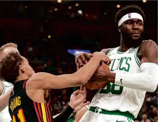  ?? TANNER PEARSON FOR THE GLOBE ?? Celtics center Neemias Queta (right) pulled his weight Sunday, compiling 7 points and 10 rebounds in just 15 minutes.