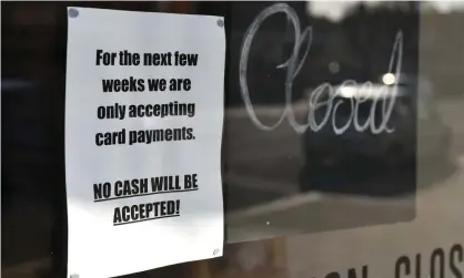  ?? Photograph: John Keeble/Getty Images ?? A sign stating that a local shop will only be accepting card payments during the coronaviru­s crisis in Leigh-on-Sea, UK.