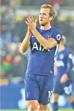  ??  ?? Tottenham Hotspur’s English striker Harry Kane applauds supporters on the pitch after the English Premier League football match between Swansea City and Tottenham Hotspur at The Liberty Stadium in Swansea, south Wales on January 2, 2018. Tottenham won...