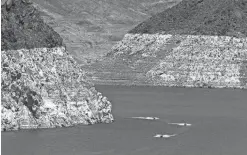  ?? MARK HENLE/THE ARIZONA REPUBLIC ?? A high-water mark is visible on the Lake Mead shoreline, indicating a 150-foot drop in the lake’s water level.