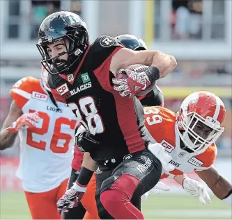  ?? JUSTIN TANG THE CANADIAN PRESS ?? Ottawa Redblacks’ Brad Sinopoloi (88) tries to make his way past B.C. Lions’ Tony Burnett (26) and Chandler Fenner (39) during the first half of a CFL football game in Ottawa on Aug. 26, 2017.