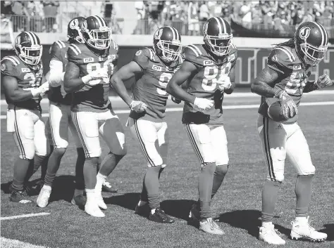  ?? TROY FLEECE ?? Saskatchew­an Roughrider­s receiver Naaman Roosevelt, far right, leads his teammates in a conga line after scoring a touchdown Sunday against the Winnipeg Blue Bombers. The Riders have had a good reason to celebrate lately as the team is on a three-game...