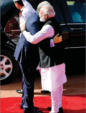  ??  ?? Prime Minister Narendra Modi embraces his Malaysian counterpar­t Najib Abdul Razak on his arrival at the President’s House in New Delhi on Saturday. India and Malaysia inked seven pacts on Saturday, including an air services agreement and a pact on...