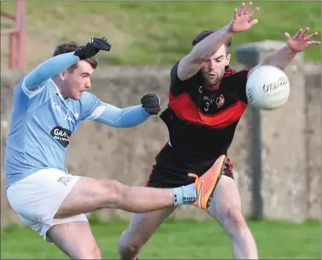  ??  ?? Dermot Campbell blocks down shot by Ross Nally during the Blues win over Dreadnots on Sunday. Pictures: Paul Connor