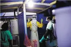  ?? AP ?? Health crisis A health worker is sprayed before he leaves the contaminat­ed zone at the Ebola treatment centre in Gueckedou, Guinea.