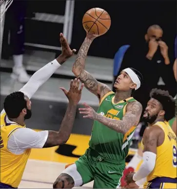  ?? Marcio Jose Sanchez Associated Press ?? JORDAN CLARKSON, shooting over Andre Drummond and the Lakers, scored a team-high 22 points and the Jazz made 15 of 33 three-point attempts to avenge Saturday’s loss at Staples Center and improve to 43-15.