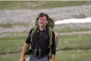  ?? Photograph: Gaspard Dussert ?? The ecologist Christophe Bonenfant on the mountainsi­de, a marmot cage strapped to his back.