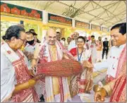  ?? PTI ?? Union home minister Amit Shah plays an instrument inside Batadrava Than in Nagaon district of Assam.