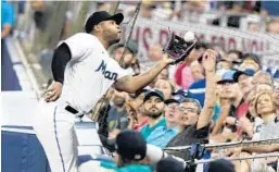  ?? WILFREDO LEE/AP ?? Marlins first baseman Jesús Aguilar catches a foul ball hit by the Mariners’ Ty France during the first inning Friday in Miami.