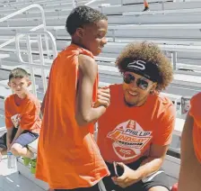  ?? Joe Amon, The Denver Post ?? Broncos running back Phillip Lindsay greets young athletes Monday at his football camp.