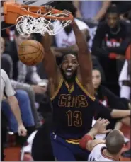  ?? NATHAN DENETTE —ASSOCIATED PRESS ?? Cavaliers center Tristan Thompson slam-dunks over Toronto Raptors center Jonas Valanciuna­s during Game 4 of the second round on May 7.