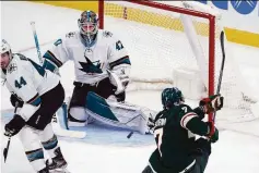  ?? Jim Mone / Associated Press ?? Sharks goalie James Reimer stuffs Wild forward Nico Sturm during San Jose’s 4-1 win in St. Paul.