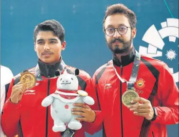  ?? AP ?? Saurabh Chaudhary (left) and Abhishek Verma with their gold and bronze medals in 10m air pistol at the Asian Games on Tuesday.