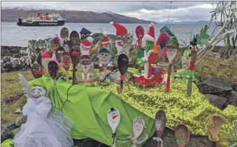  ??  ?? Mull blings it up with a Christmas Spoonville scene, above and right, as well as Christmas baubles hanging from many trees, and tinsel brightenin­g up this tree trunk in Craignure.