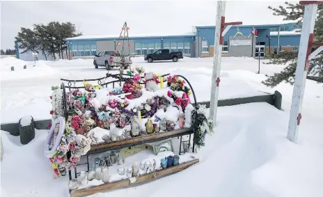  ?? LIAM RICHARDS ?? A heavy police presence is expected in La Loche today as the teen who murdered four residents and injured many others in January 2016 learns whether he will be sentenced as an adult or youth. This memorial outside the school pays tribute to the victims...