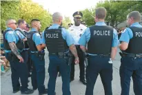  ?? JOHN J. KIM/CHICAGO TRIBUNE ?? Deputy Chief Larry Snelling, center, talks with officers before a prayer service in memory of Chicago police Officer Ella French outside the 22nd District on Aug. 11, 2021.