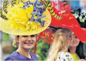  ??  ?? Hatiquette: extravagan­t hats are the order of the day on Ladies’ Day at Royal Ascot. Below, the Queen wears one of Marie O’Regan’s creations in Hungary in 1993