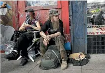  ?? AP ?? Stormy Nichole Day, left, sits on a sidewalk on Haight St with Nord (last name not given) and his dog Hobo while interviewe­d about being homeless in San Francisco.