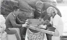  ??  ?? Workers clean oyster shells at the Dibba Bay Oyster Farm in Fujairah, the United Arab Emirates.