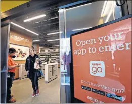  ?? [ASSOCIATED PRESS FILE PHOTO] ?? A shopper leaves an Amazon Go store in Seattle on Jan. 22, 2018. Cameras and sensors in the store keep track of what the customer takes and charge it to their credit or debit card when they leave.