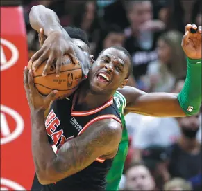  ?? LYNNE SLADKY / AP ?? Dion Waiters of the Miami Heat fends off Boston Celtics’ Jaylen Brown during the first half of Wednesday’s NBA clash in Miami. The Heat halted the Celtics’ 16-game winning streak with a 104-98 victory.