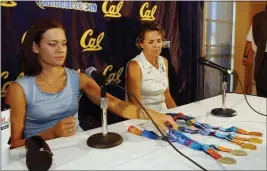  ?? MARCIO JOSE SANCHEZ — THE ASSOCIATED PRESS ?? This file photo shows U.S. Olympic swimmer Natalie Coughlin, left, displaying the five medals she won competing in the Athens Olympics as her coach Teri McKeever, right, sits next to her on the campus of UC Berkeley in Berkeley.