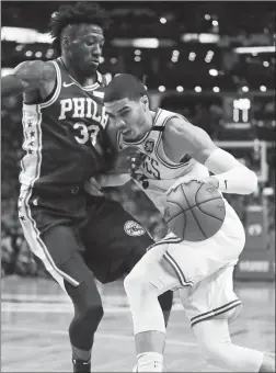  ?? Associated Press photo ?? Boston Celtics forward Jayson Tatum, right, drives to the basket against Philadelph­ia 76ers forward Robert Covington during the first quarter of Game 5 of an NBA basketball playoff series in Boston, Wednesday.