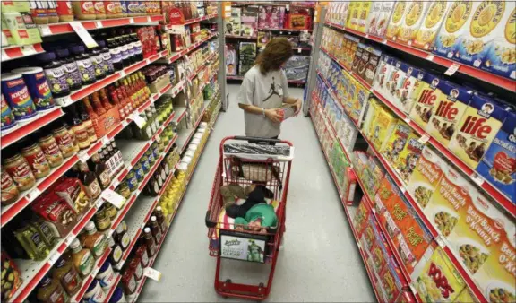  ?? TONY GUTIERREZ — THE ASSOCIATED PRESS FILE ?? Alicia Ortiz shops through the cereal aisle as her daughter Aaliyah Garcia catches a short nap in the shopping cart at a Family Dollar store in Waco, Texas. Don’t be intimidate­d by the idea of a weekly big supermarke­t shop. Buying a lot in one fell swoop helps keep your kitchen organized and well-stocked all week.