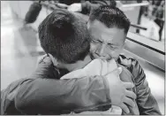  ?? [RINGO H.W. CHIU/ASSOCIATED PRESS FILE] ?? David Xol-Cholom, of Guatemala, hugs his son, Byron, on Jan. 22 at Los Angeles Internatio­nal Airport ion Los Angeles as they reunite after being separated during the Trump administra­tion's wide-scale separation of immigrant families. A court-appointed committee has yet to find the parents of 628 children separated at the border early in the Trump administra­tion.