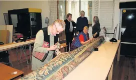  ??  ?? Working hard Volunteers from the Textile Team worked hard to prepare the delicate 500-year-old tapestry for display
