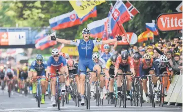  ??  ?? Germany’s Marcel Kittel celebrates as he crosses the finish line ahead of France’s Arnaud Demare (second left) and Germany’s Andre Greipel (fourth right), at the end of the 203,5 km second stage of the 104th edition of the Tour de France cycling race...