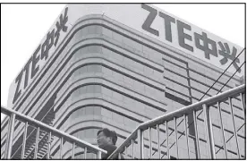  ??  ?? A man walks past a building with the ZTE logos in Beijing. As Chinese officials prepare to hold talks with their counterpar­t in Washington, the two countries are reportedly attempting a swap: Relief for ZTE in return for Beijing dropping plans to...