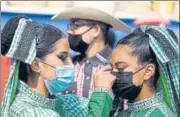  ?? AFP ?? Students dressed in traditiona­l costumes put on make up during a march to demand Covid-19 vaccinatio­n in Mexico City.