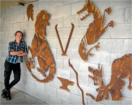  ?? PHOTO: MURRAY WILSON/FAIRFAX NZ ?? The new metal mural at Awatapu College, with designer and former pupil Danica Thompson.