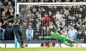  ?? AFP/VNA Photo ?? PAY THE PENALTY: Real Madrid's defender Antonio Rudiger scores the winning penalty past Manchester City's goalkeeper Ederson during the penalty shootout during the UEFA Champions League quarter- nal second-leg match on Wednesday.