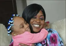  ?? Lake Fong/Post-Gazette ?? Sheila Givens, 33, with her 3--year-old daughter Quincia Nelson. Ms. Givens graduated from the Energy Innovation Center, which allowed her to get a job with UPMC Montefiore.