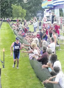  ?? PHOTO: ODT FILES ?? Starting small . . . Wanaka GP Andrew McLeod is greeted by a small crowd during the run transition of the first Challenge Wanaka event in 2007.