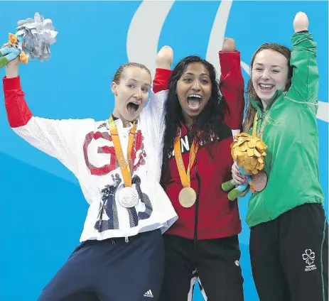  ?? BUDA MENDES/GETTY IMAGES ?? From left, silver medallist Claire Cashmore of Britain, gold medallist Katarina Roxon of Canada and bronze medallist Ellen Keane of Ireland celebrate on the podium following the SB8 100-metre breaststro­ke final at the Paralympic­s in Rio on Wednesday.