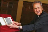  ?? Tony Gentile / Associated Press ?? Prefect of the Vatican Library Bishop Cesare Pasini leafs through an authentic Christophe­r Columbus letter. Below: A detail of the eight-page text.
