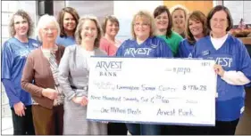  ?? LYNN KUTTER ENTERPRISE-LEADER ?? Arvest Bank in Farmington donated $976.28 to the Farmington Senior Center and its Meals on Wheels program through its annual One Million Meals programs. Imogene Clayton, front, left, and Lisa McClelland, center director, accept the money on behalf of...