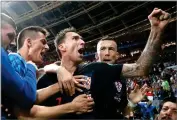  ?? AP PHOTO BY FRANK AUGSTEIN ?? Croatia’s Mario Mandzukic, center, celebrates after scoring his side’s second goal during the semifinal match between Croatia and England on Wednesday, July 11.