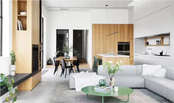  ??  ?? LIVING A calming palette makes this the place to relax. European oak joinery features throughout. Fireplace, steel mantel with Jetmaster fire. Rug, Halcyon Lake. Green steel coffee table, Chris Connell Design. Vase by Stephen Benwell. Casual dining...