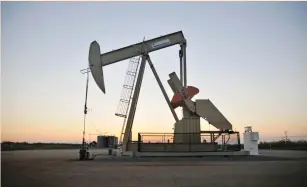  ?? (Nick Oxford/Reuters) ?? A PUMP JACK operates at a well site leased by Devon Energy Production Company near Guthrie, Oklahoma. Hedge funds and private-equity firms have given producers a range of new and traditiona­l financial levers they can pull as needed to keep shale rigs...
