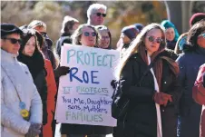  ?? LUIS SÁNCHEZ SATURNO/THE NEW MEXICAN ?? Erika Harding of Albuquerqu­e holds a sign in support of abortion access during a Roe v. Wade Day demonstrat­ion Thursday at the Capitol.