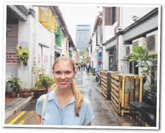  ??  ?? Holli strolls through Haji Lane in the Arab Quarter of Singapore.