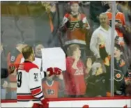  ?? TOM MIHALEK — THE ASSOCIATED PRESS ?? Carolina Hurricanes’ Bryan Bickell greets fans at Wells Fargo Center during the warmups prior to the start of his last NHL game. He is retiring at 31 due to his diagnosis of multiple sclerosis.